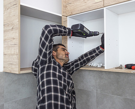 Man Refacing Kitchen Cabinets