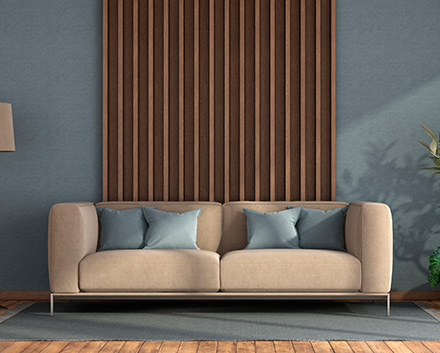 Couch in Front of an Accent Wall Painted a Dark Color With Wood Slats